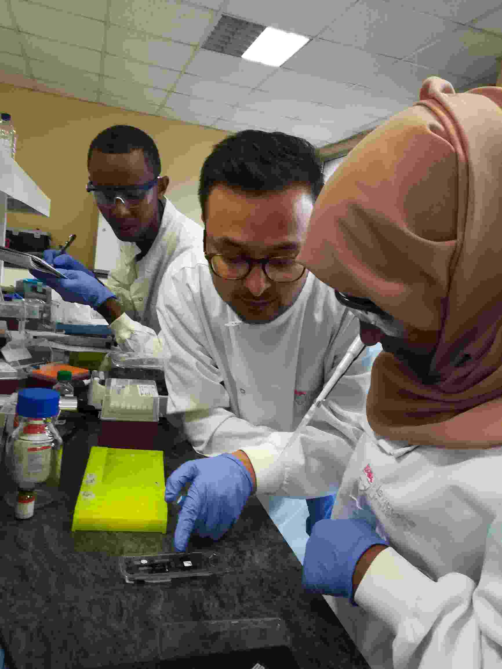 Image shows Dr Kishor Acharya and other Hub members working on water samples in a laboratory