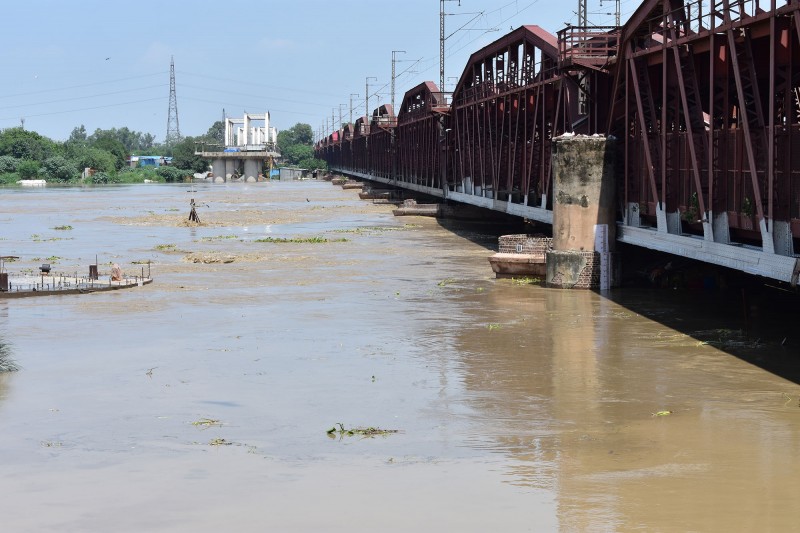 The flood-swollen Yamuna river level rises above the danger mark on Delhi's Lohe-ka-Pul Bridge (also known as the Old Yamuna Bridge), one of the longest and oldest bridges in India