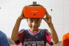 A young school pupil looks up as they prepare to use a virtual reality headset thumbnail