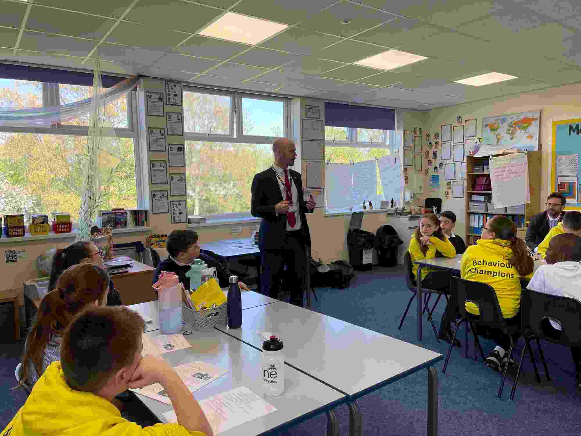 The honourable North of Tyne Mayor, Jamie Driscoll, stands in the middle of a classroom while answering students' questions