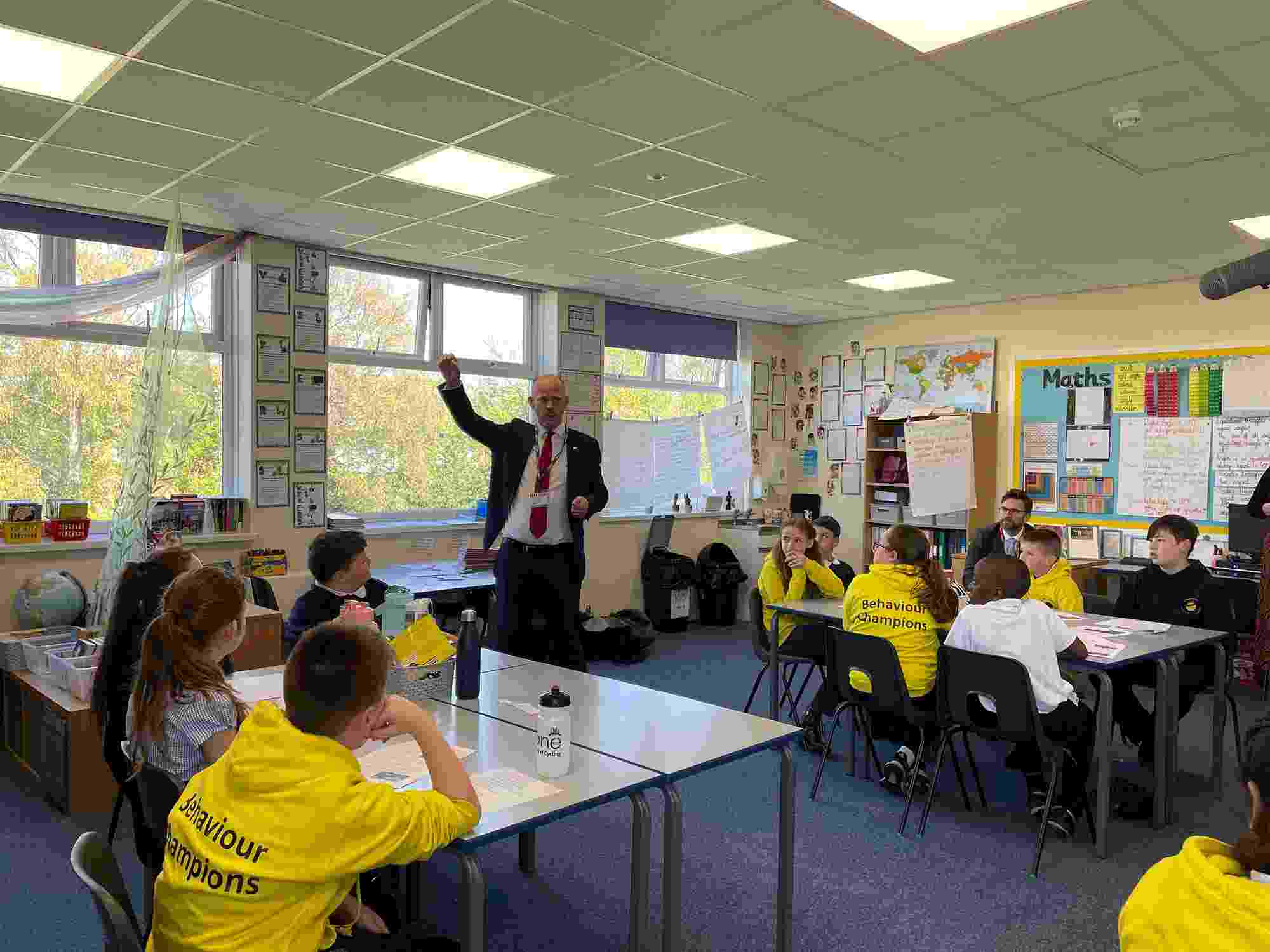 The honourable North of Tyne Mayor, Jamie Driscoll, stands in the middle of a classroom while answering students' questions