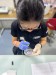 A member of the NUMed team analyses the contents of a petri dish as part of AMR and water quality work thumbnail