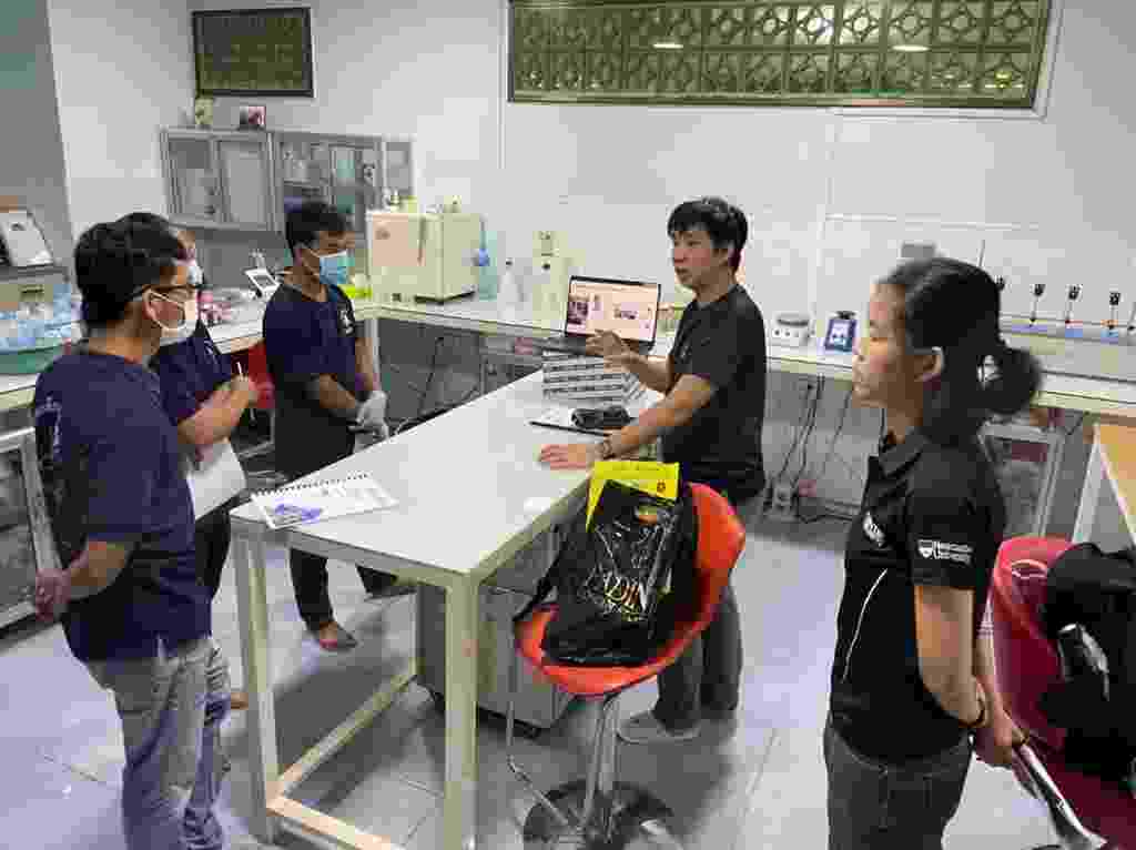 Members of the NUMed team discuss findings with members of Water for Cambodia