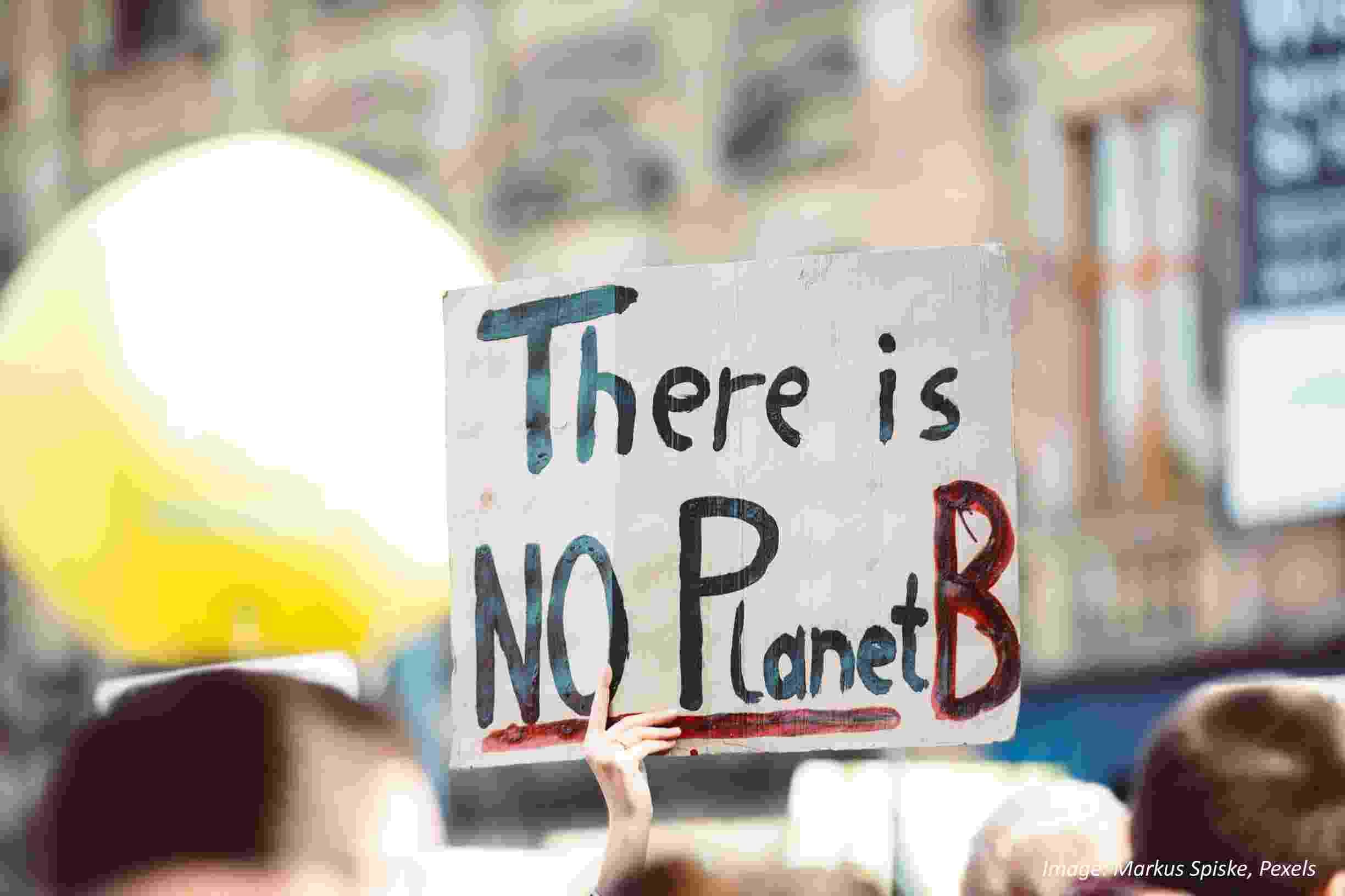 Climate change protester holds up a sign reading 'There is no Planet B'