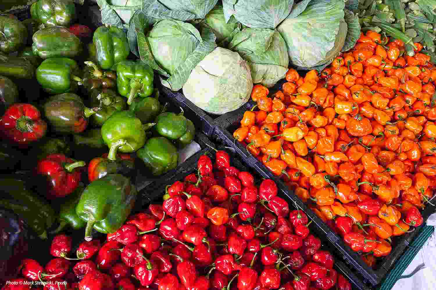 Close up of a selection of brightly coloured fruit and vegetables on a market stall