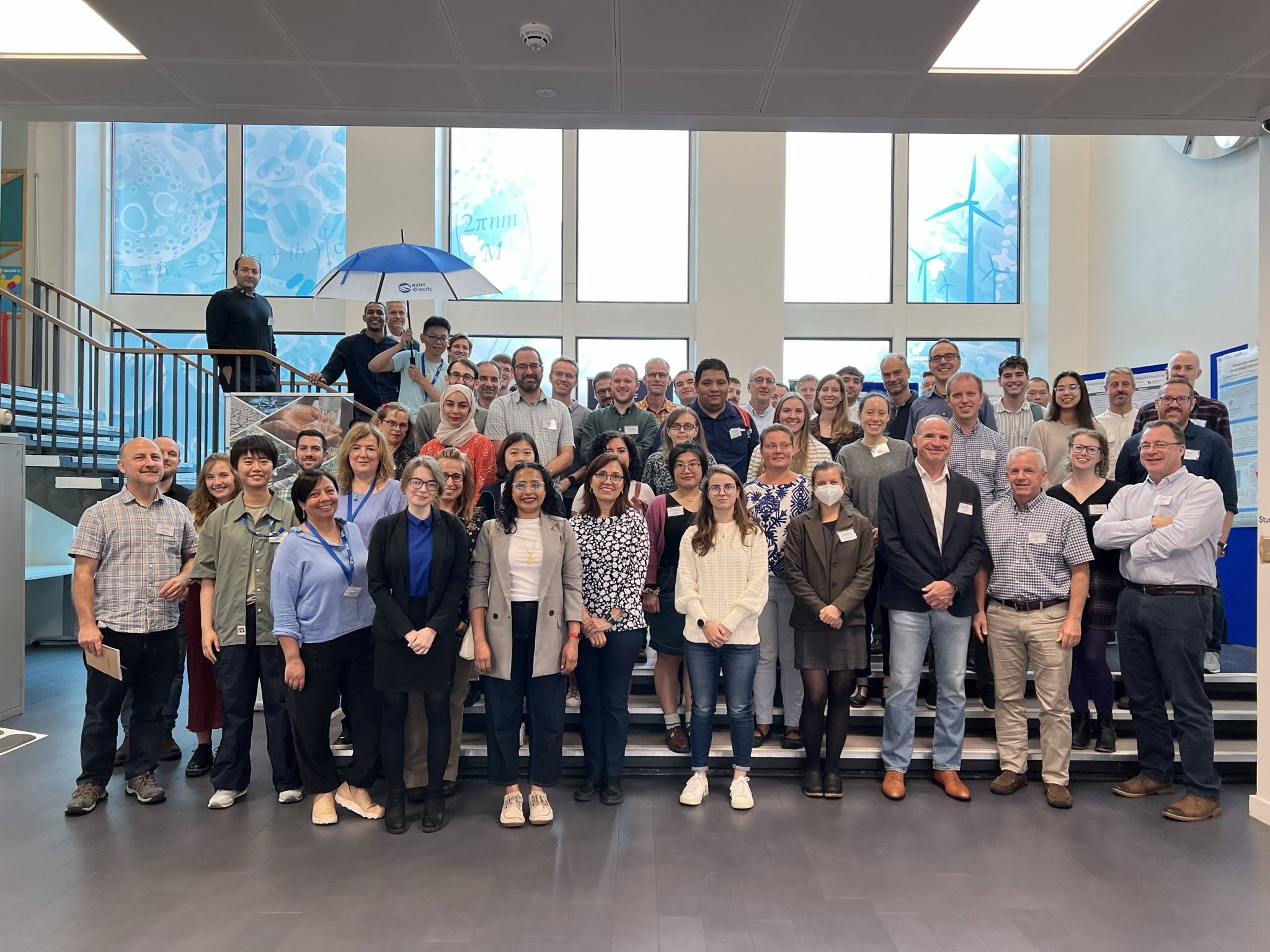 The large group of GFP Annual Conference delegates stand together, spread across several steps, smiling at the camera.