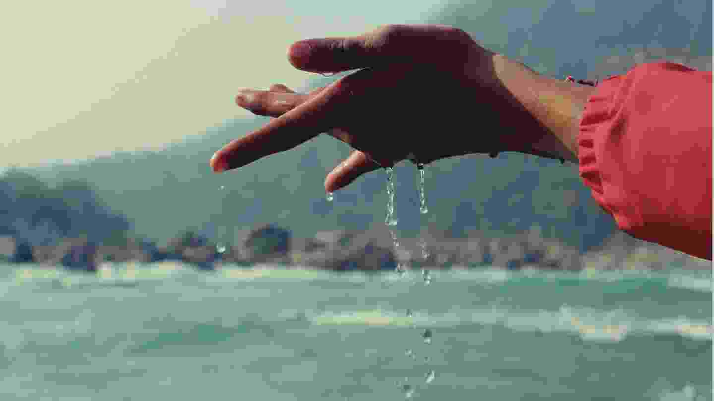 water droplets falling from an open palm